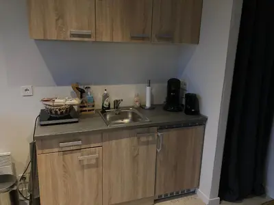 a kitchen with a sink and a counter top at Het oude strandhuis in Uitgeest