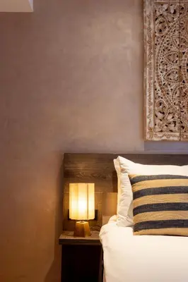 a bedroom with a bed with a lamp on a table at Dream Hotel Amsterdam in Amsterdam