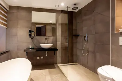a bathroom with a sink and a toilet and a shower at Dream Hotel Amsterdam in Amsterdam