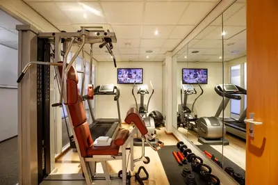 a gym with treadmills and elliptical machines at Dikker & Thijs Hotel in Amsterdam