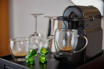 a coffee maker and two glasses on a table at Dikker & Thijs Hotel in Amsterdam