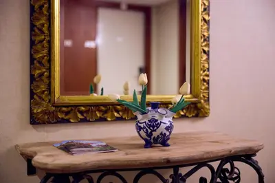 a vase on a table in front of a mirror at Dikker & Thijs Hotel in Amsterdam
