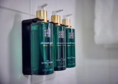 four green batteries are lined up on a wall at Dikker & Thijs Hotel in Amsterdam