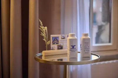 a side table with two bottles of sunscreen on it at Dikker & Thijs Hotel in Amsterdam