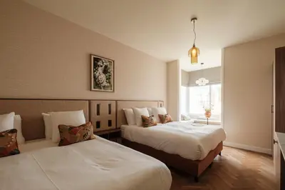 a bedroom with two beds and a window at House of Adam in Amsterdam