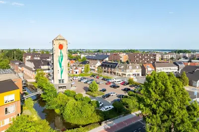 an aerial view of a town with a parking lot at B&B De Tulpentoren in Roelofarendsveen