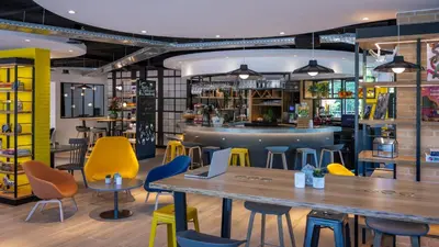 a restaurant with tables and chairs and a bar at Campanile Hotel & Restaurant Amsterdam Zuid-Oost in Amsterdam