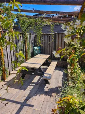a wooden picnic table sitting on a patio at Eco lodge Utrecht Leidsche Rijn in Utrecht