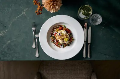 a plate of food on a table with silverware at Van der Valk Hotel Volendam - Recently renovated in Volendam