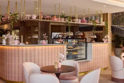 a restaurant with pink tiles and tables and chairs at Van der Valk Hotel Volendam - Recently renovated in Volendam
