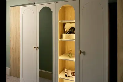 a closet with white doors and shelves in a room at Van der Valk Hotel Volendam - Recently renovated in Volendam