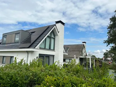 a house with a solar roof on top of it at Holiday Home Pieper Luxe by Interhome in Noordwijk