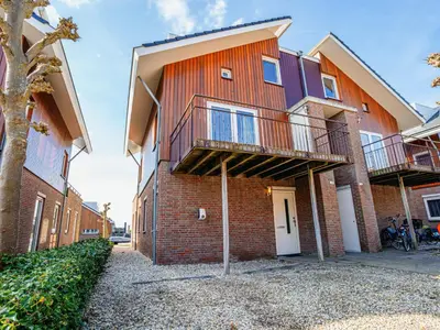 a brick building with two balconies on it at Apartment Westergeest Luxe by Interhome in Uitgeest