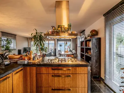 a large kitchen with wooden cabinets and a sink at NOVA Houseboat DELUXE Free Bikes in Amsterdam