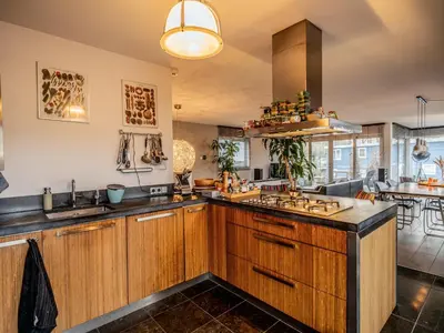 a kitchen with wooden cabinets and a counter top at NOVA Houseboat DELUXE Free Bikes in Amsterdam