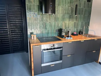a kitchen with a counter with a stove top oven at Résidence Beaufort in Zandvoort