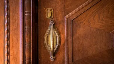 a brown wooden door with a hook on it at Hotel Aalders in Amsterdam