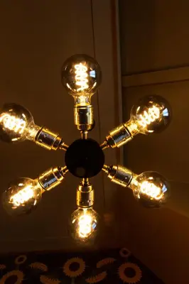 a chandelier with lights hanging from a ceiling at Hotel Aalders in Amsterdam