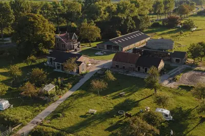 an aerial view of a house and a barn at Groepsaccommodatie op natuurboerderij Huize Blokland in Hem