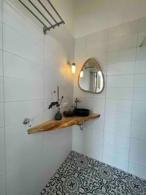 a bathroom with a sink and a mirror at Groepsaccommodatie op natuurboerderij Huize Blokland in Hem