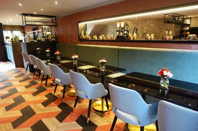 a row of tables and chairs in a restaurant at Prinsengracht Hotel in Amsterdam