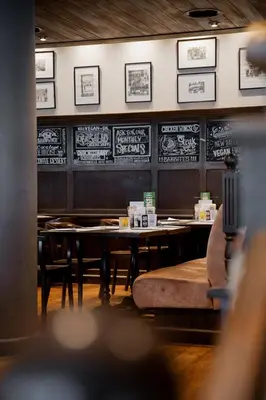 a restaurant with tables and chairs and a chalkboard at Steigenberger Airport Hotel Amsterdam in Schiphol