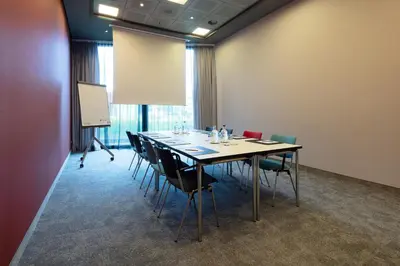 a conference room with a long table and chairs at Steigenberger Airport Hotel Amsterdam in Schiphol