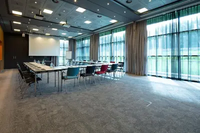a conference room with a long table and chairs at Steigenberger Airport Hotel Amsterdam in Schiphol