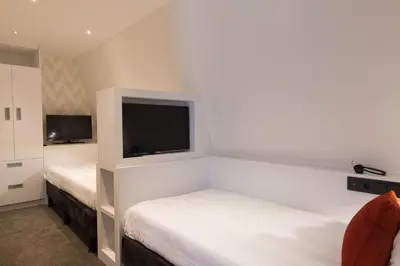 a hotel room with two beds and a flat screen tv at Van der Valk Hotel de Bilt-Utrecht in De Bilt