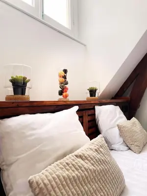 a bed with white sheets and pillows in a room at Hotel Plantage in Amsterdam