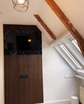 a tv in the corner of a room in a attic at Hotel Plantage in Amsterdam
