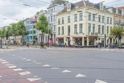 an empty street in a city with buildings at Hotel Plantage in Amsterdam