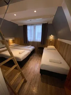 a room with two bunk beds and a window at Hotel Old Quarter in Amsterdam