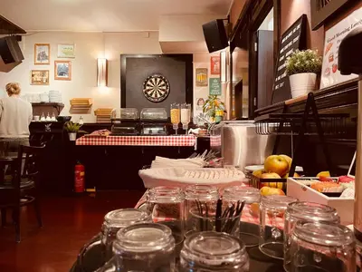 a restaurant with a counter with glasses on it at Hotel Old Quarter in Amsterdam