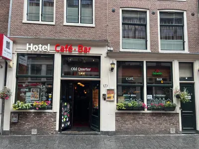 a hotel cafe bar with flowers in the windows at Hotel Old Quarter in Amsterdam