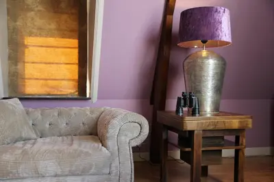 a lamp sitting on a table next to a couch at Augusta Hotel in IJmuiden