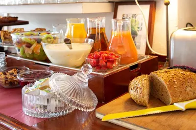 a table with bread and other food items on it at Amsterdam House Hotel in Amsterdam