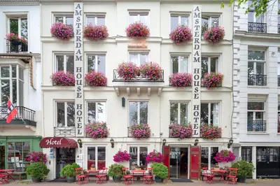 a hotel with flowers on the side of a building at Amsterdam House Hotel in Amsterdam
