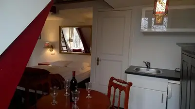 a kitchen with a table with a sink and a bed at Amsterdam House Hotel in Amsterdam