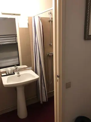 a bathroom with a sink and a shower at Amsterdam House Hotel in Amsterdam