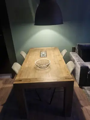 a wooden table with a plate on top of it at Leuke tussenwoning in Hoogkarspel