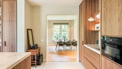 a kitchen with a dining room with a table at Villa van Reenenpark in Bergen