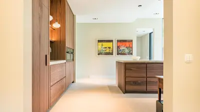 a kitchen with wooden cabinets and a counter top at Villa van Reenenpark in Bergen