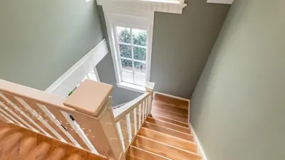 a staircase with a chair and a window at Villa van Reenenpark in Bergen