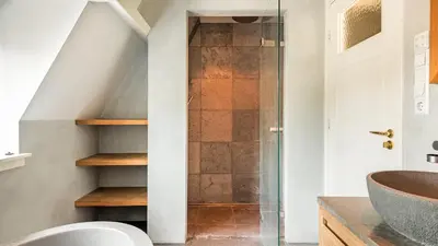 a bathroom with a shower and a sink at Villa van Reenenpark in Bergen