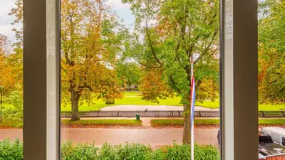a view of a park from a window at Villa van Reenenpark in Bergen