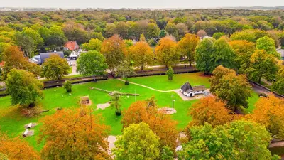 an aerial view of a park with trees and a train at Villa van Reenenpark in Bergen