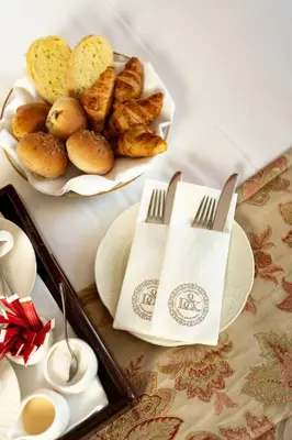 a table with a plate of bread and a plate of pastries at Landgoed Duin & Kruidberg in Santpoort-Noord