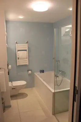 a bathroom with a tub and a toilet and a sink at Landgoed Duin & Kruidberg in Santpoort-Noord