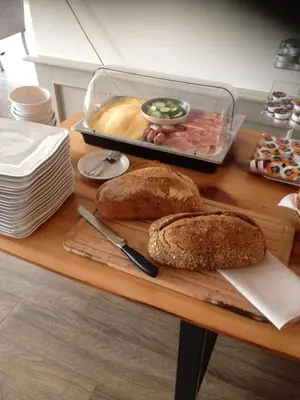 a table topped with bread and a tray of food at Het Rechthuis in Uithoorn